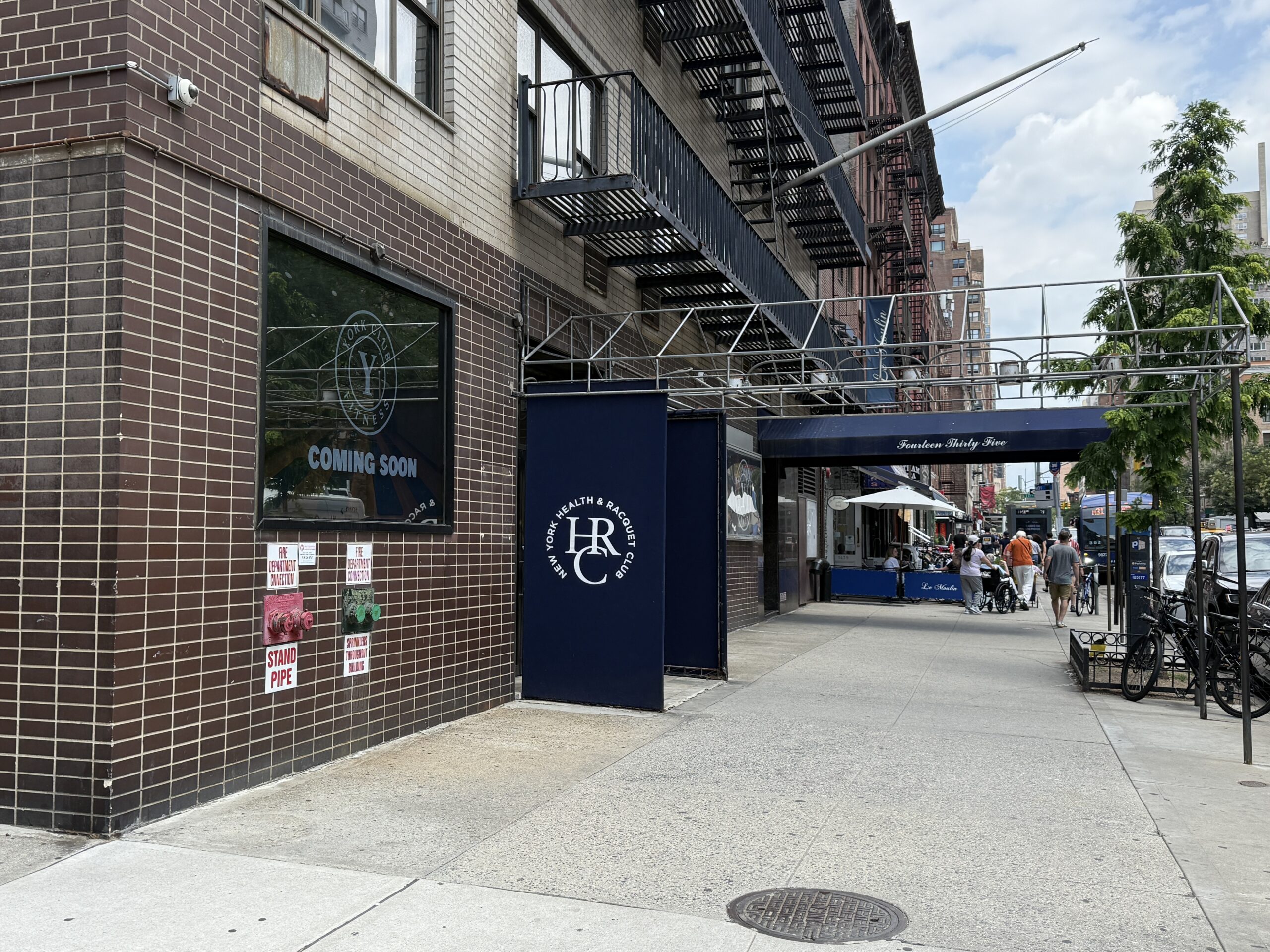 Image shows the brick exterior of a vacant fitness club.