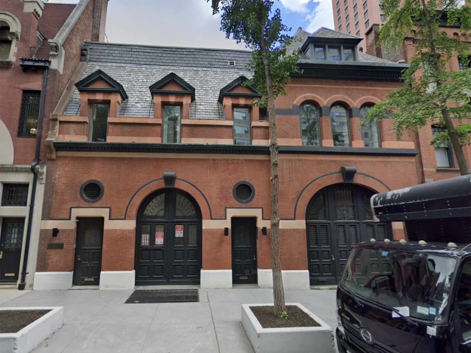 Image shows red mansion.
