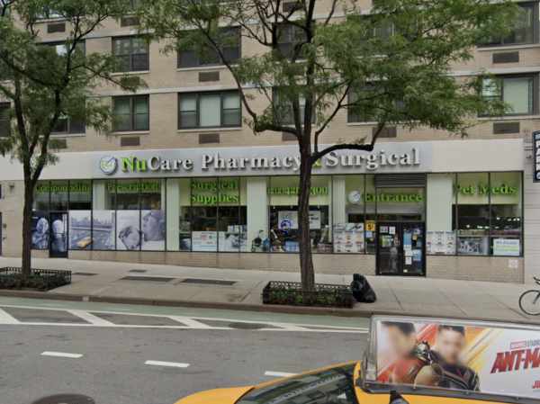 Image shows a pharmacy on a city block.