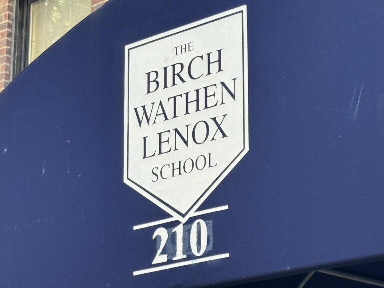 Image shows a blue awning with white logo for the "Birch Wathen Lenox School."