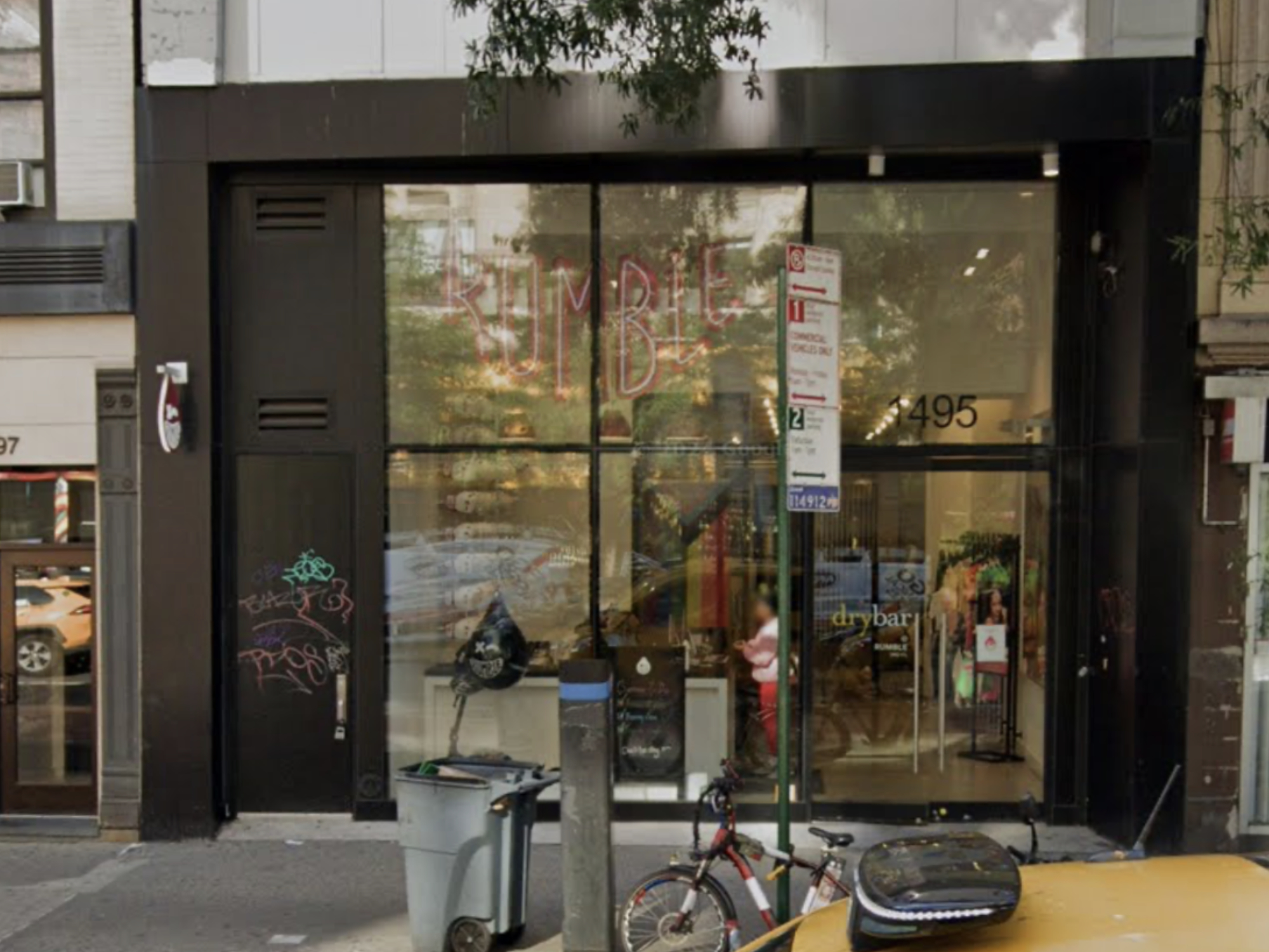 Image shows a two-story storefront with floor to ceiling windows and black trim.