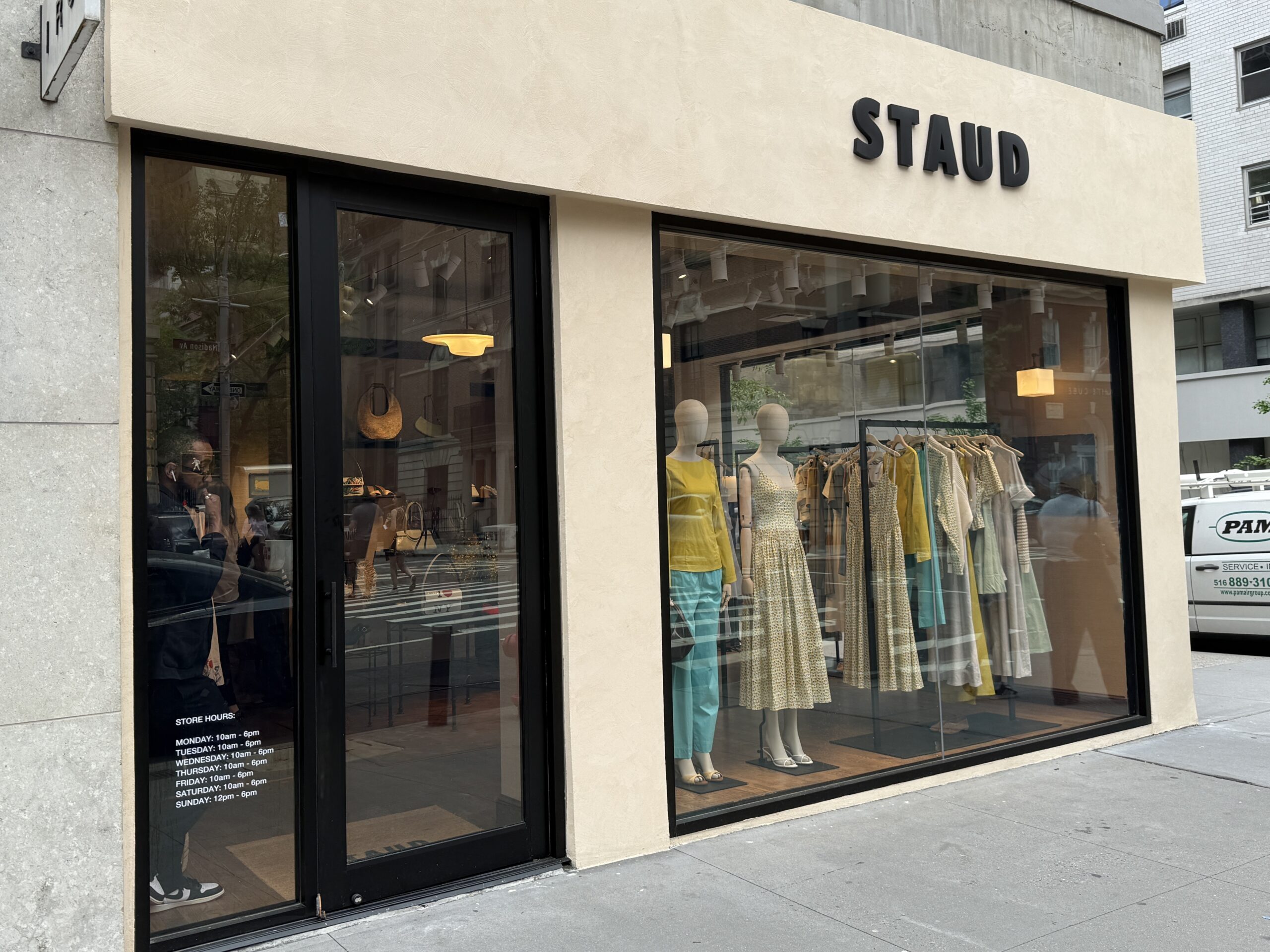 Photo shows a beige storefront for a luxury clothing brand 'Staud.'