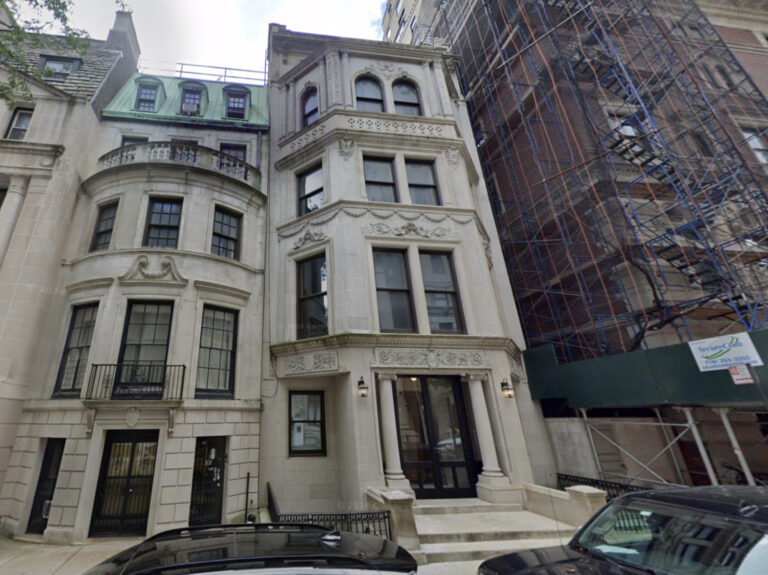 Photo shows a seven-story limestone mansion.