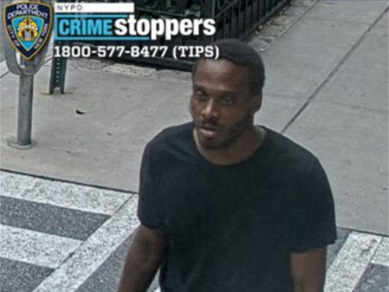 Surveillance image shows a man in a black t-shirt.
