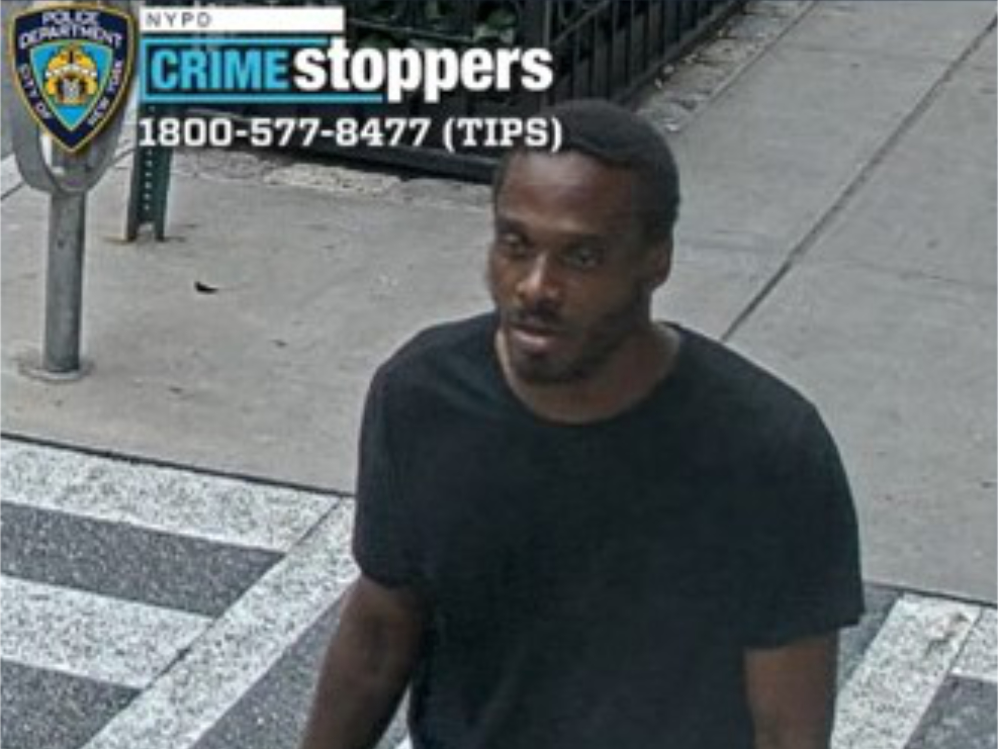 Surveillance image shows a man in a black t-shirt.