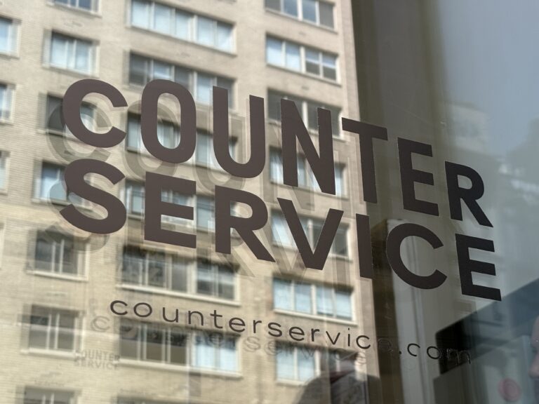 Photo shows black lettering on glass reading "Counter Service."