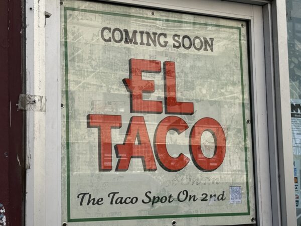 Photo shows a sign in a window reading 'Coming Soon El Taco The Taco Spot on 2nd.'